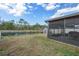 Serene backyard with a picturesque view of a lake, privacy fence, and shed at 13357 Marble Sands Ct, Hudson, FL 34669