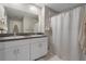 Bathroom featuring a double vanity, neutral tile, and modern fixtures at 13357 Marble Sands Ct, Hudson, FL 34669