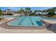 A community pool features designated lap lanes and a jacuzzi area near a clubhouse and shaded pavilions at 13357 Marble Sands Ct, Hudson, FL 34669