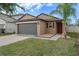 Charming one-story home with well-maintained lawn and attached two car garage at 13357 Marble Sands Ct, Hudson, FL 34669