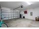 Clean garage with open door showing painted walls, garage door, and room for 2-car parking at 13357 Marble Sands Ct, Hudson, FL 34669