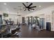 Community gym with modern machines, weights, mirrored wall and multiple ceiling fans for a complete workout experience at 13357 Marble Sands Ct, Hudson, FL 34669