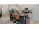 Modern kitchen boasts a large island, granite countertops, white cabinetry, and stainless steel appliances at 13357 Marble Sands Ct, Hudson, FL 34669