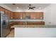 A spacious kitchen features wood cabinets, stainless steel appliances, granite countertops, and pendant lighting at 13357 Marble Sands Ct, Hudson, FL 34669
