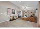 Bright living room with a comfortable seating area, TV, ceiling fan, and smooth tile floors at 13357 Marble Sands Ct, Hudson, FL 34669