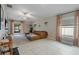 Well-lit living room with tile floors, a comfortable sofa, and access to the screened patio at 13357 Marble Sands Ct, Hudson, FL 34669