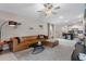 Open-concept living room with tile flooring, neutral walls, ceiling fan, and seamless flow to kitchen at 13357 Marble Sands Ct, Hudson, FL 34669