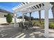 This outdoor patio area offers a pergola, chairs, and a table, great for relaxing or entertaining guests at 13357 Marble Sands Ct, Hudson, FL 34669