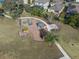 Community playground featuring modern play equipment and shaded seating areas at 13357 Marble Sands Ct, Hudson, FL 34669