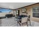 Cozy screened porch with outdoor seating, grill, and tv, perfect for relaxation at 13357 Marble Sands Ct, Hudson, FL 34669