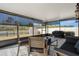 Relaxing screened porch with outdoor seating, grill, and serene lake view at 13357 Marble Sands Ct, Hudson, FL 34669