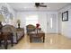 Inviting living room with tile floors, stylish decor, a view into the kitchen, and a ceiling fan at 14006 Arbor Knoll Cir, Tampa, FL 33625