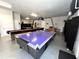 Spacious game room features an air hockey table, shuffleboard table, and additional entertainment options at 1421 Apollo Beach Blvd, Apollo Beach, FL 33572