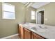 Bathroom featuring double sinks with wood cabinets and a large mirror, providing ample counter space at 1442 Lenton Rose Ct, Trinity, FL 34655