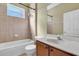 Well-lit bathroom featuring tile walls, a combined shower and tub, and a wood vanity at 1442 Lenton Rose Ct, Trinity, FL 34655