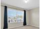 Bedroom featuring a window with blue curtains, offering natural light and a view of the neighborhood at 1442 Lenton Rose Ct, Trinity, FL 34655