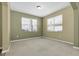 Neutral bedroom features carpeted floors and two large windows providing ample natural light at 1442 Lenton Rose Ct, Trinity, FL 34655