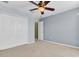 Bedroom with a ceiling fan and a double door closet with a view to another room at 1442 Lenton Rose Ct, Trinity, FL 34655