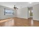Light-filled bedroom with hardwood floors, a ceiling fan, and a window overlooking the neighborhood at 1442 Lenton Rose Ct, Trinity, FL 34655