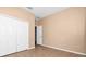 Neutral bedroom with tile flooring, a walk-in closet, and white doors at 1442 Lenton Rose Ct, Trinity, FL 34655