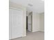 Clean and organized closet space with white doors, offering ample storage and easy access at 1442 Lenton Rose Ct, Trinity, FL 34655