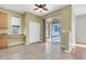 Well-lit dining room featuring neutral tile floor, closet, desk space and sliding glass door to patio at 1442 Lenton Rose Ct, Trinity, FL 34655