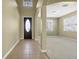 Bright foyer with tile flooring, high ceilings, arched doorways, and a decorative front door at 1442 Lenton Rose Ct, Trinity, FL 34655