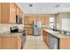 Open kitchen featuring stainless steel appliances, granite countertops, and ample cabinet space at 1442 Lenton Rose Ct, Trinity, FL 34655