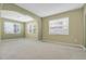 Spacious living room with neutral carpet, multiple windows for natural light and arched doorway at 1442 Lenton Rose Ct, Trinity, FL 34655