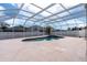 Screened-in pool with a hot tub and a spacious concrete deck perfect for outdoor lounging at 1442 Lenton Rose Ct, Trinity, FL 34655