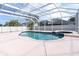 Inviting screened-in pool with attached jacuzzi offers a private outdoor oasis at 1442 Lenton Rose Ct, Trinity, FL 34655