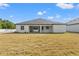 Spacious backyard featuring a covered patio, providing ample space for outdoor activities and relaxation at 14421 Nonna Sky Drive Dr, Spring Hill, FL 34609