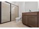 Bathroom featuring a walk-in shower, toilet and a dark wood vanity at 14421 Nonna Sky Drive Dr, Spring Hill, FL 34609