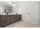 Bathroom features a double vanity with dark wood cabinets and modern fixtures at 14421 Nonna Sky Drive Dr, Spring Hill, FL 34609