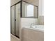 Bathroom featuring tiled tub and a frameless glass-enclosed shower at 14421 Nonna Sky Drive Dr, Spring Hill, FL 34609