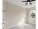 An empty bedroom featuring tiled floors, a ceiling fan, and a bright window at 14421 Nonna Sky Drive Dr, Spring Hill, FL 34609