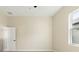 An empty bedroom featuring tiled floors and a bright window at 14421 Nonna Sky Drive Dr, Spring Hill, FL 34609
