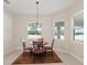 Bright breakfast nook featuring a round table, four chairs, and natural light from surrounding windows at 14421 Nonna Sky Drive Dr, Spring Hill, FL 34609