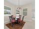 Bright breakfast nook featuring a round table, four chairs, and natural light from surrounding windows at 14421 Nonna Sky Drive Dr, Spring Hill, FL 34609