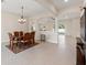 Open dining room with tiled floors, traditional furniture and modern lighting at 14421 Nonna Sky Drive Dr, Spring Hill, FL 34609