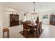 Open dining room with tiled floors, traditional furniture and modern lighting at 14421 Nonna Sky Drive Dr, Spring Hill, FL 34609