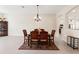 Open dining room with tiled floors, traditional furniture and modern lighting at 14421 Nonna Sky Drive Dr, Spring Hill, FL 34609
