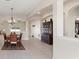 Open dining room with tiled floors, traditional furniture and modern lighting at 14421 Nonna Sky Drive Dr, Spring Hill, FL 34609