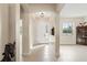 Inviting foyer featuring neutral tile flooring, arched doorways, and a view into the adjacent living spaces at 14421 Nonna Sky Drive Dr, Spring Hill, FL 34609