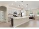 Bright kitchen boasts stainless appliances, pendant lighting, and an expansive center island with a sink at 14421 Nonna Sky Drive Dr, Spring Hill, FL 34609