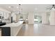 Open floorplan featuring a kitchen island, adjacent dining area and living room with sliding glass doors to the patio at 14421 Nonna Sky Drive Dr, Spring Hill, FL 34609