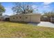 Large backyard with a combination of grass and pavers, fully fenced for privacy at 1709 W Dempsey Ave, Tampa, FL 33603