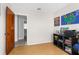Additional bedroom space with wood floors and easy access to the attached bathroom at 1709 W Dempsey Ave, Tampa, FL 33603