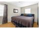 Comfortable bedroom featuring natural light, wood flooring, and a calming color scheme at 1709 W Dempsey Ave, Tampa, FL 33603