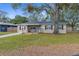 Charming single-story home features a front porch, well-maintained lawn, and mature shade tree at 1709 W Dempsey Ave, Tampa, FL 33603